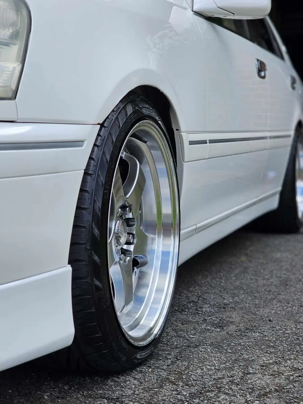 a white car with a tire that says michelin on it