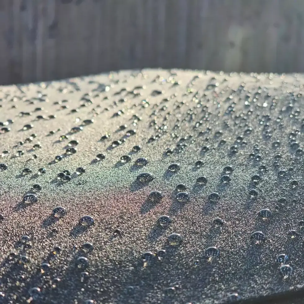 a close up of water drops on a soft top surface