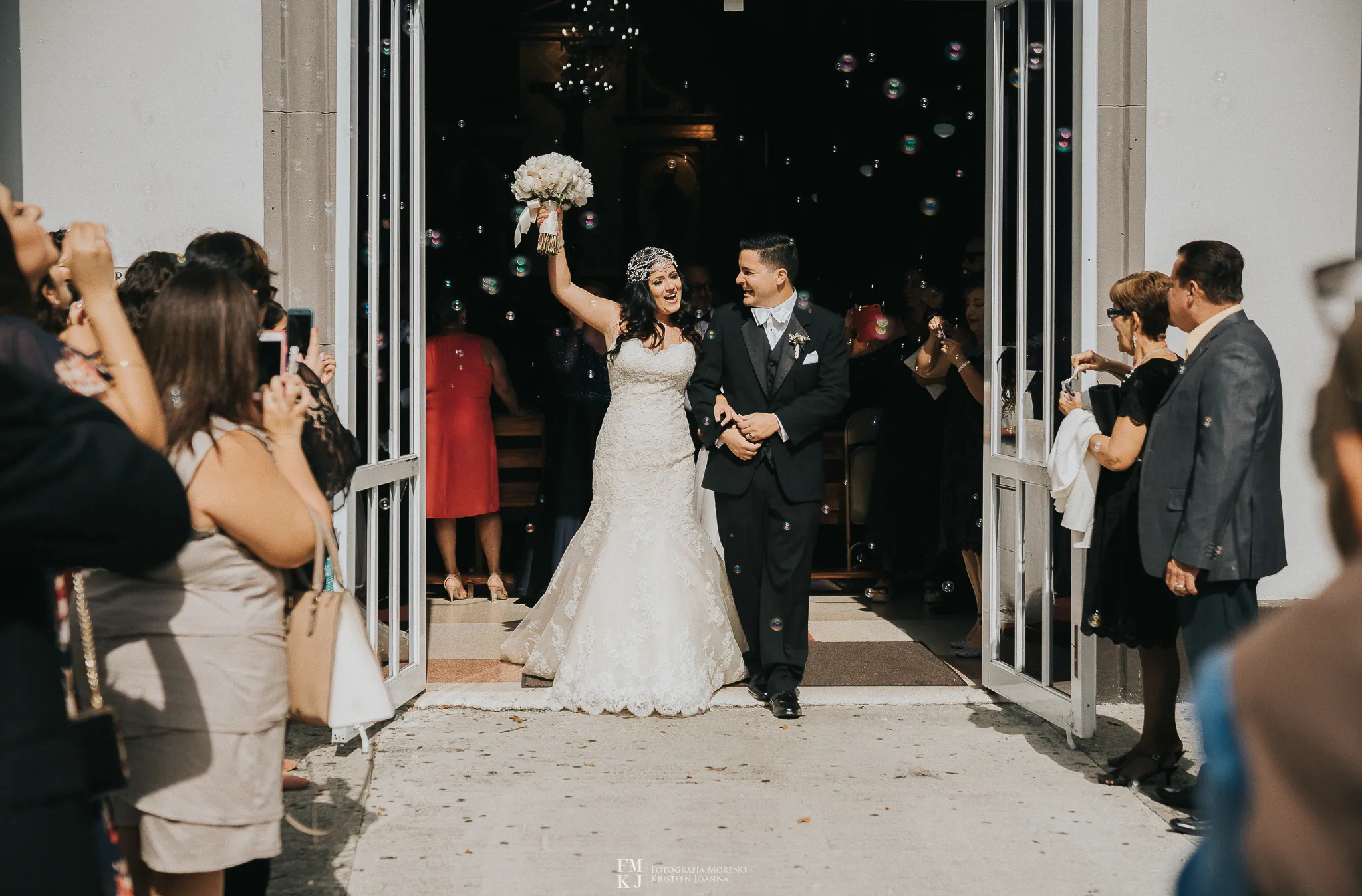 bride and groom celebrating coming out from church