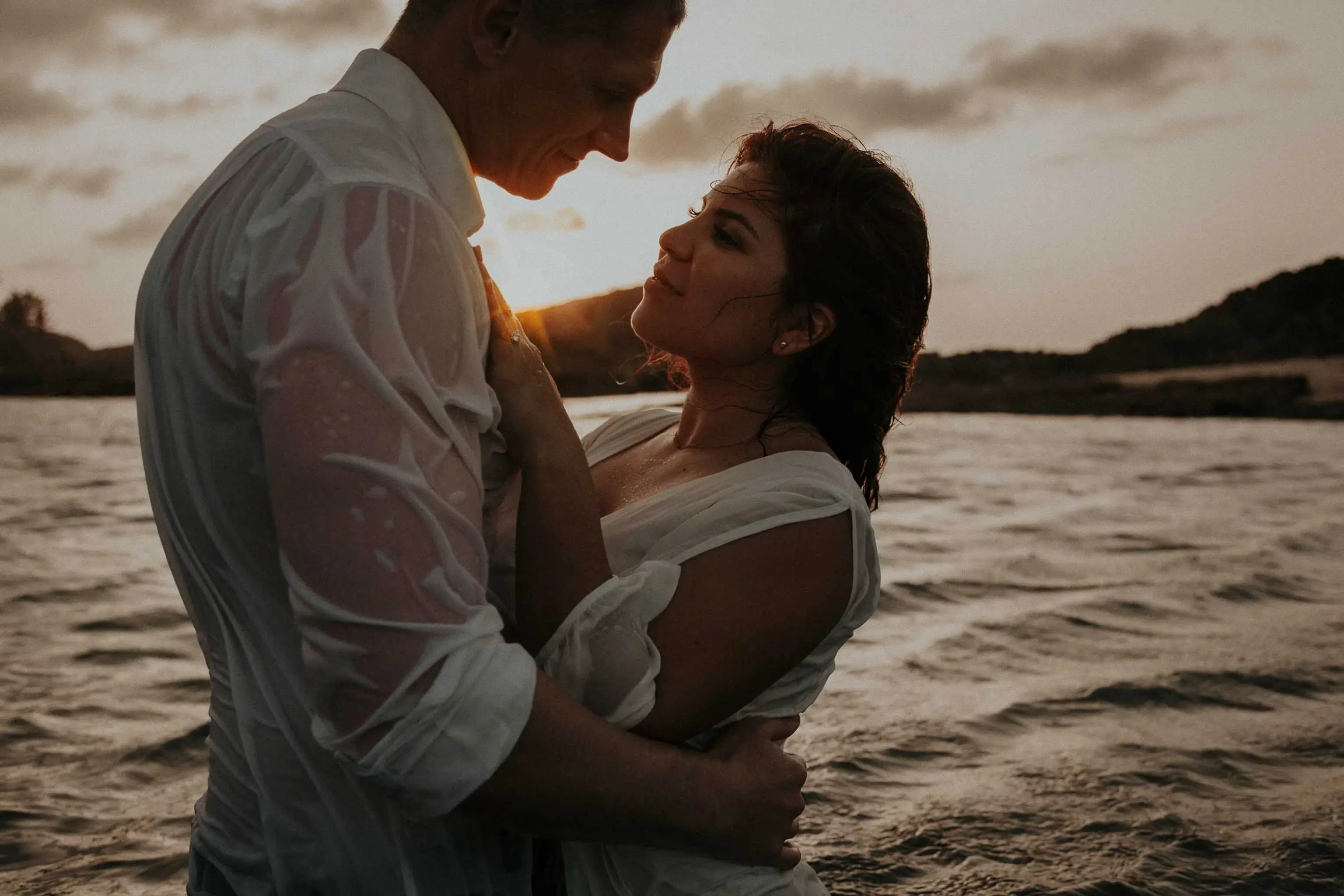 Couple in the beach hugging at sunset posing in Puerto Rico