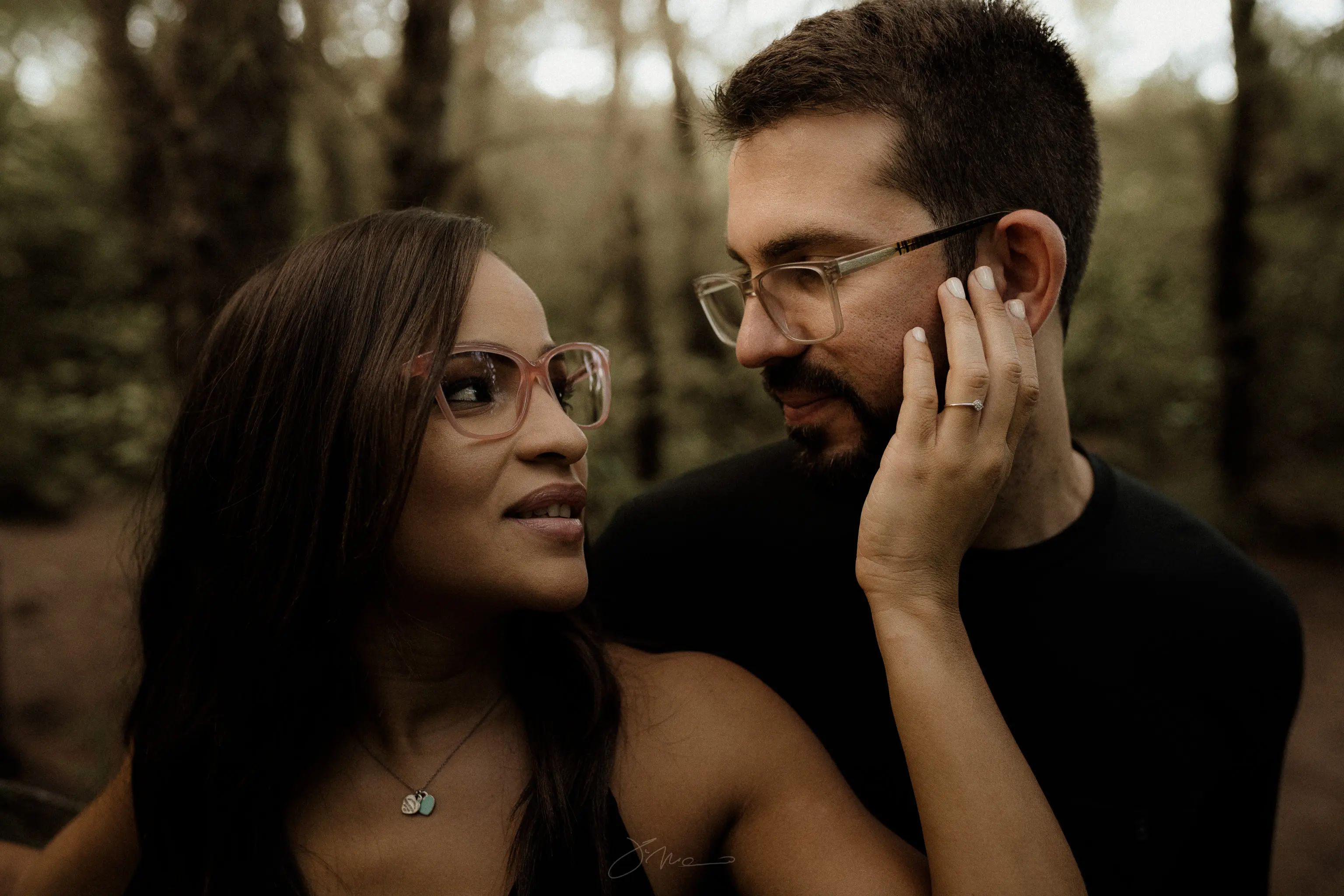 Couple in the woods posing during sunset for a photo shoot