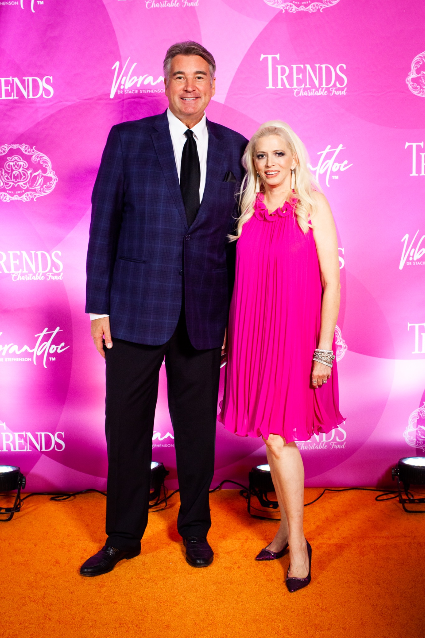 Guests in front of the pink Trends Charitable Fund backdrop