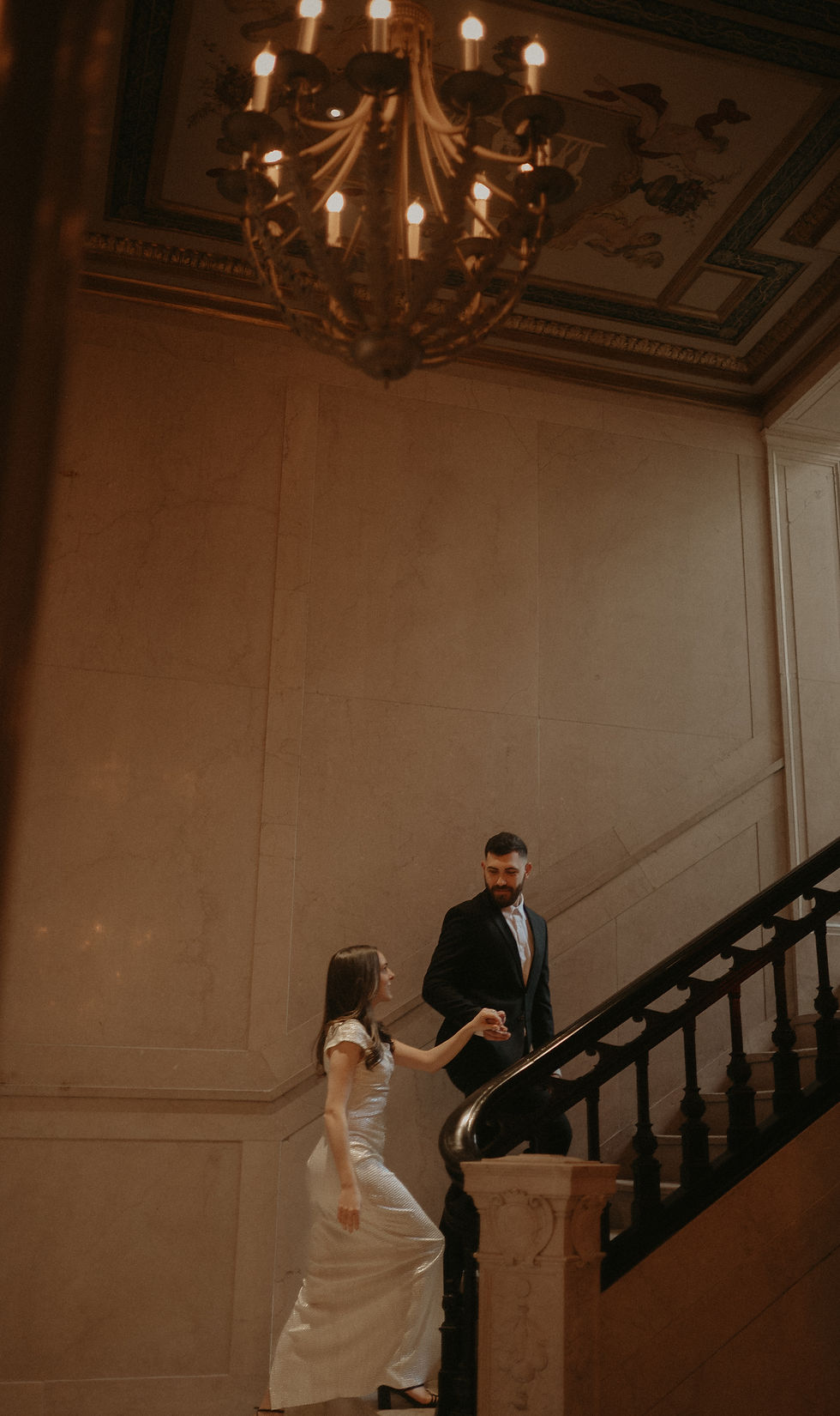 Engaged couple sharing a romantic moment inside Book Tower in Detroit, captured by luxury wedding photographer Disjah Lyons.