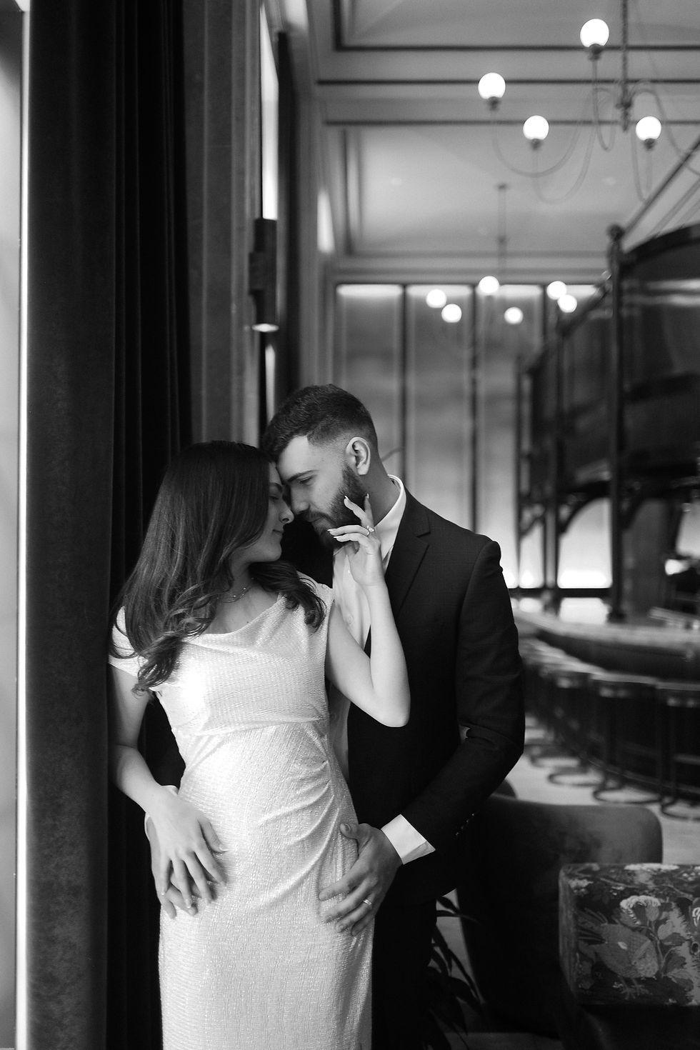 Elegant engagement session in the luxurious lounge of Book Tower, Detroit, featuring warm golden tones