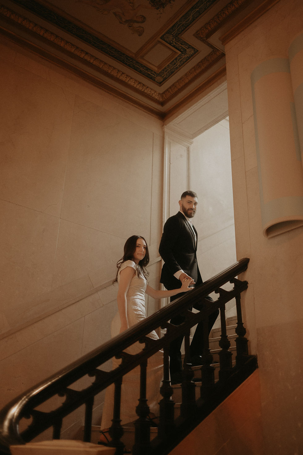 Elegant engagement session in the luxurious lounge of Book Tower, Detroit, featuring warm golden tones