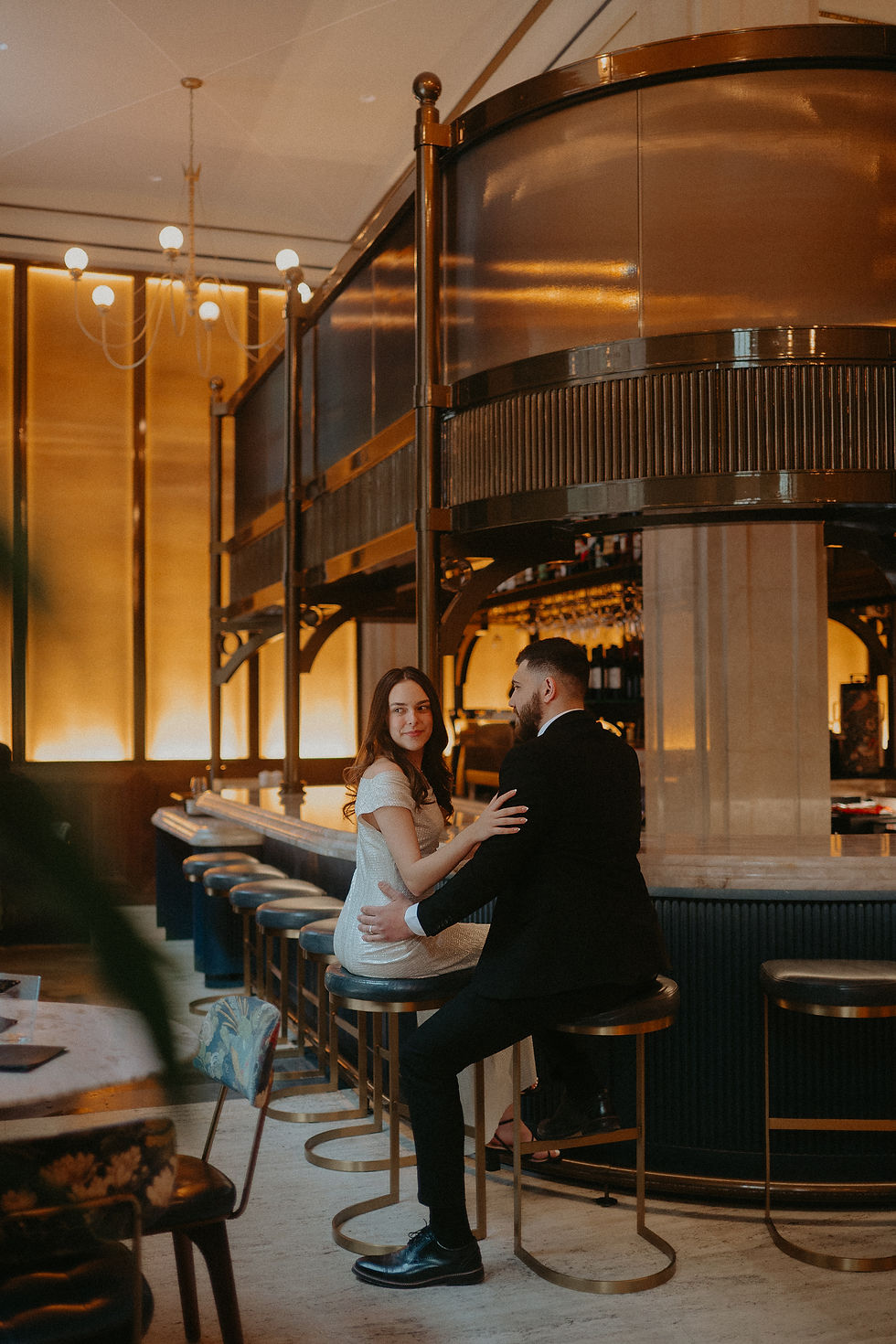 Elegant engagement session in the luxurious lounge of Book Tower, Detroit, featuring warm golden tones
