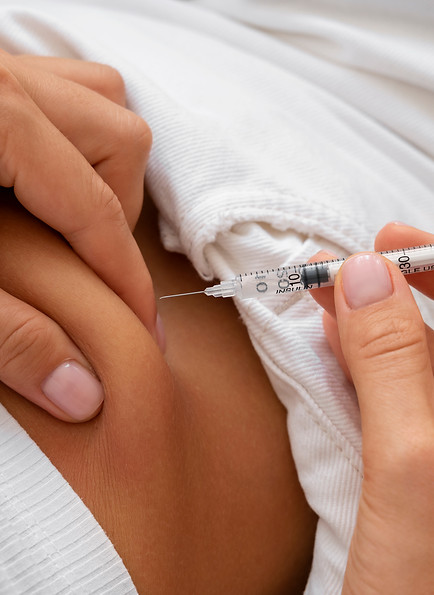 high-angle-woman-injecting-insulin-home.jpg