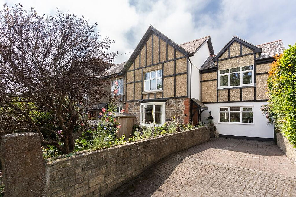 Traditional Cornish home with Tudor-style detailing, stonework and a sensitively integrated extension beside a landscaped driveway