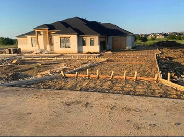 Residential driveway rebar and form prepared to pour concrete.