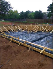 Residential foundation preparation with rebar already in place.