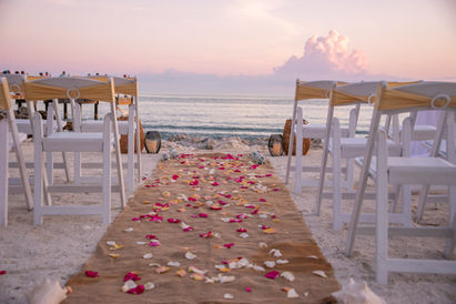 bridal aisle with rose petals and tropical wedding chairs on the ocean in the Florida keys engaged couples. Florida brides, Florida grooms, key west Florida elopement officiant, destination weddings beach sand ceremonies