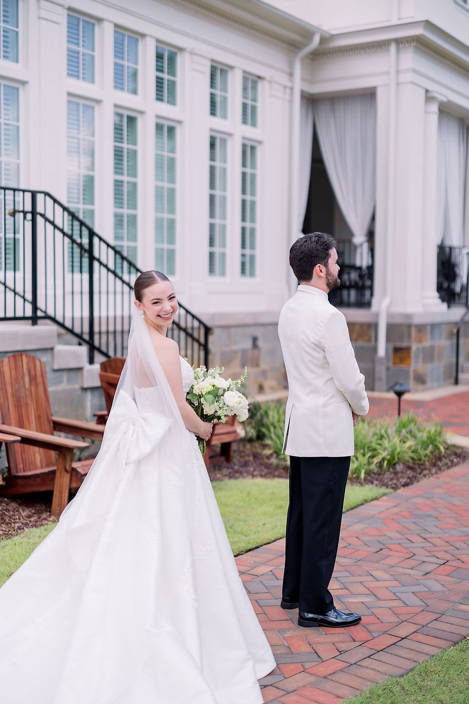 The groom stands with his back to the approaching bride as he waits to see her for the first time on their wedding day (Photo by Kara Beth Carr Photography)