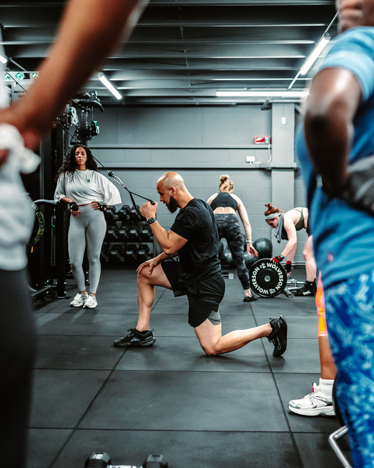 Gym training scene with coach and clients at Intent Boxing
