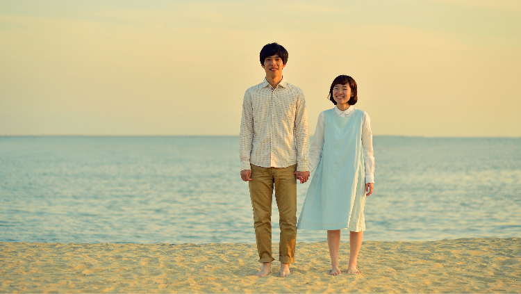 Smiling young couple holding hands