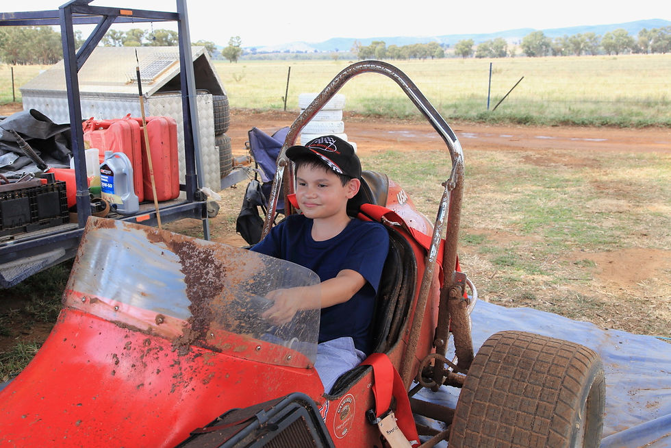 Future racer Atticus Fang enjoys a close-up look at one of Gasworks Motorsport's vintage speedway karts