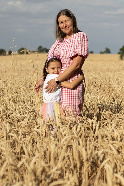Sunny day photoshoot in Papworrth everard in grain fields with mum and daughter hugging