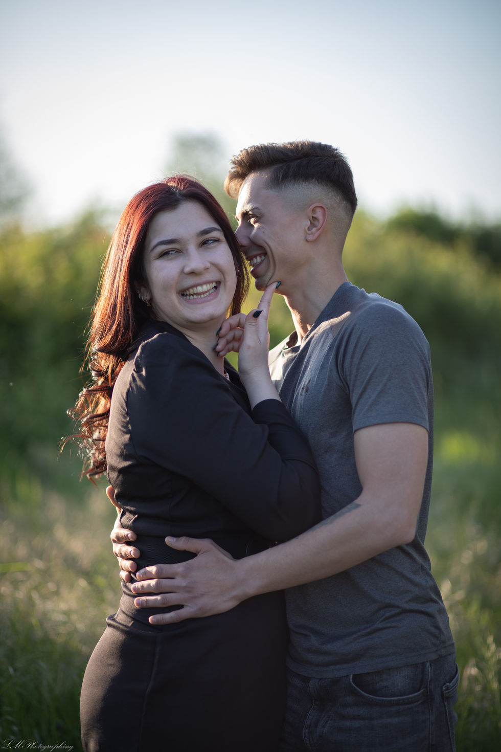 a man and a woman are hugging and the woman is smiling
