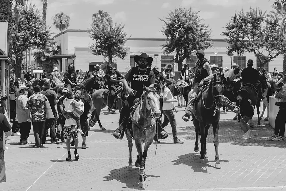 Black cowboys riding in the tradition of the Compton Cowboys, modern Black rodeo heritage