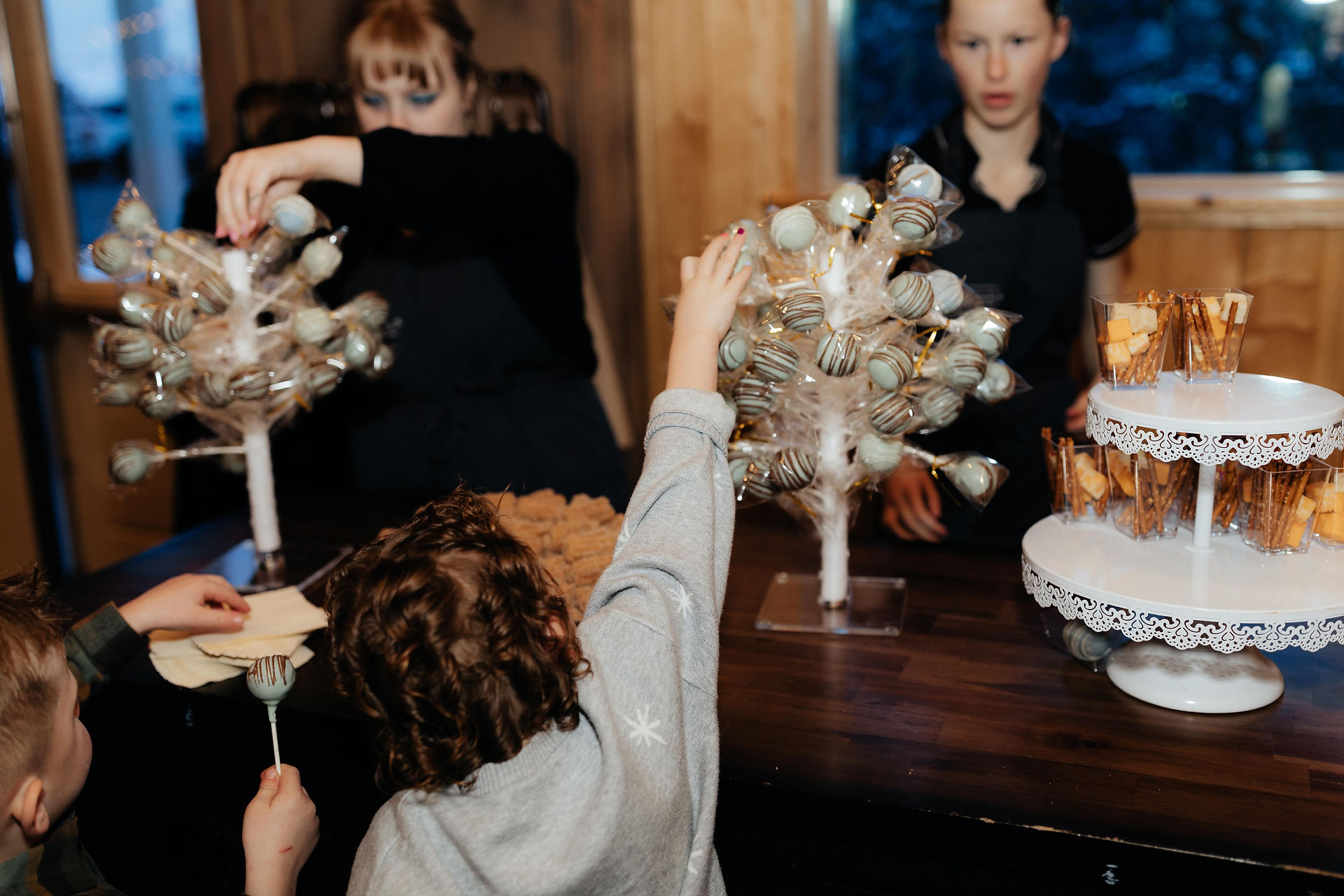 Children grabbingpops at reception