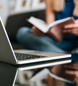 laptop-table-near-woman-reading-book-hom