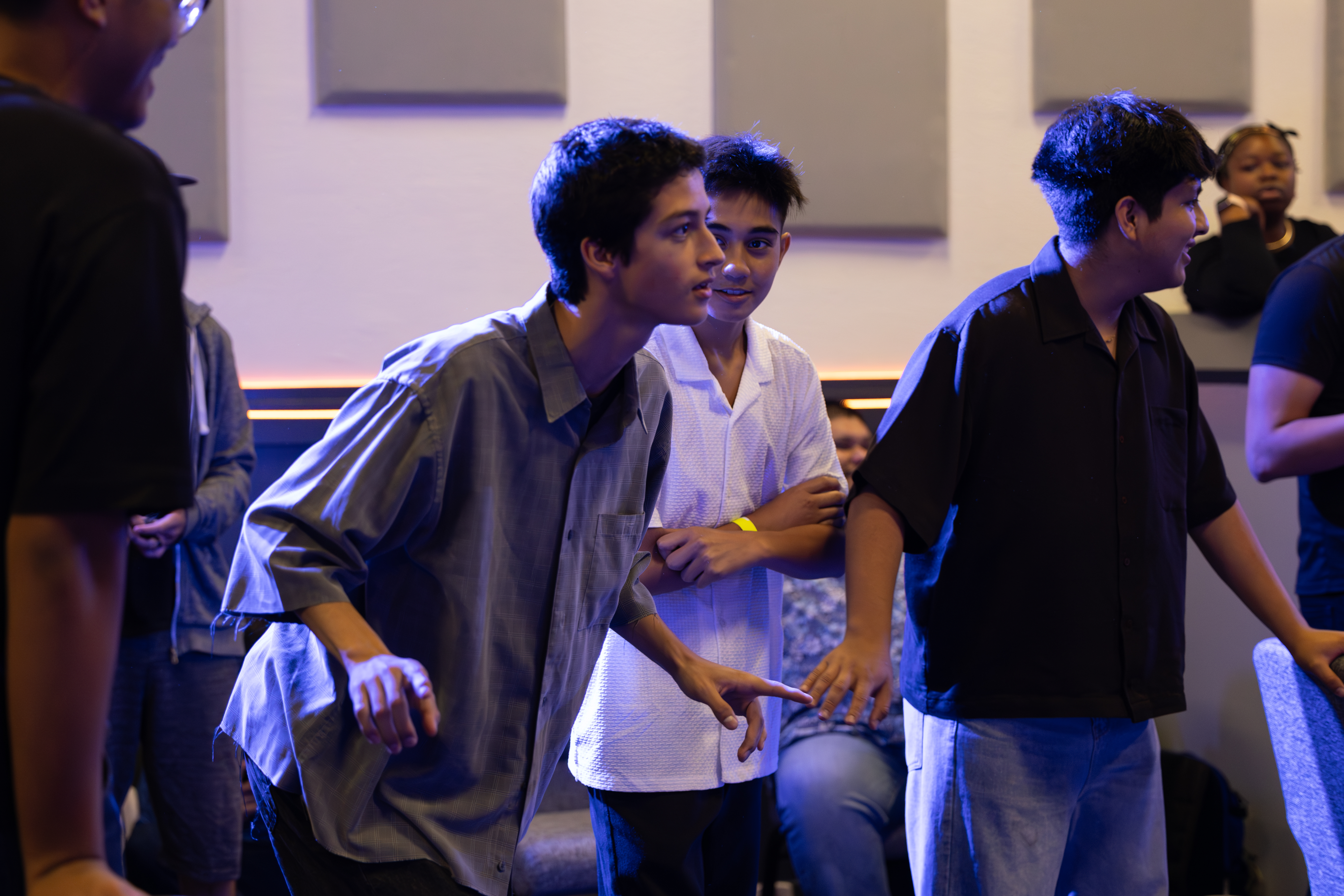 Youth standing in church youth room laughing together