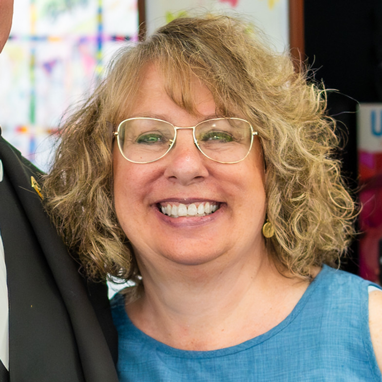 A couple smiling at an event.