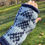 Thumbnail: Hand wearing blue and white knitted glove outdoors on a sunny day.