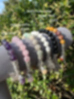 Thumbnail: Various gemstone bracelets, including Amethyst, Rose Quartz, and Black Onyx, in natural light.