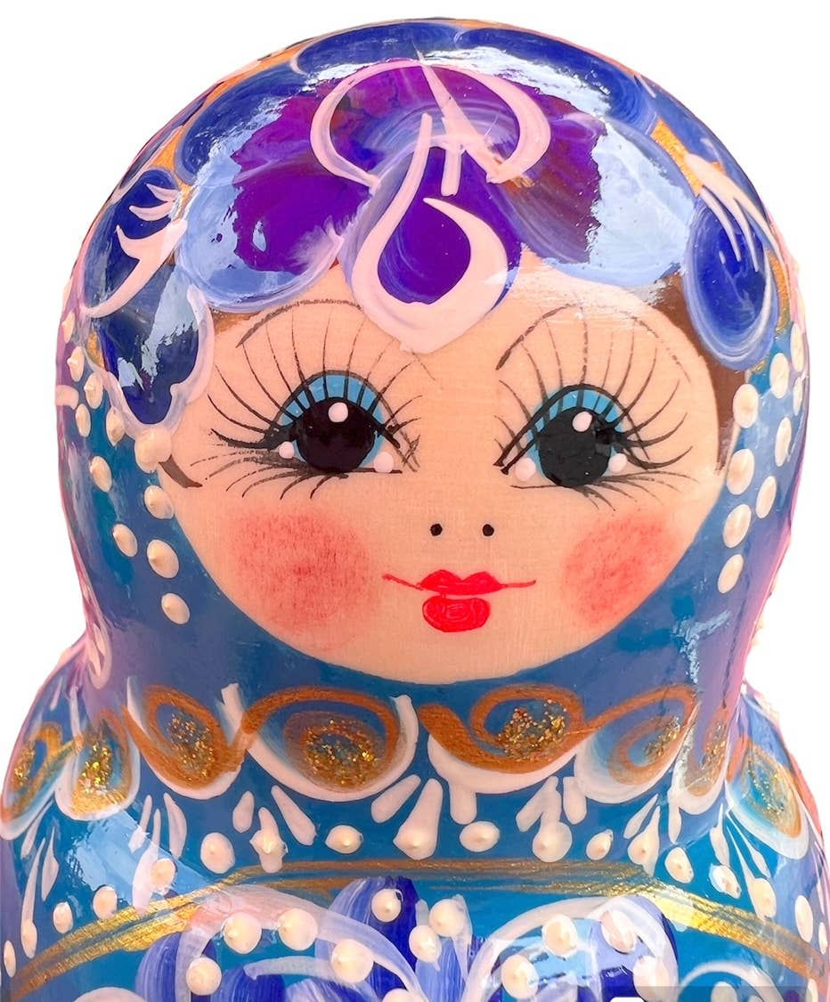 Close-up of LARGE BLUE Floral Nesting Dolls Set, 7 pcs/9" with blue details and floral design.