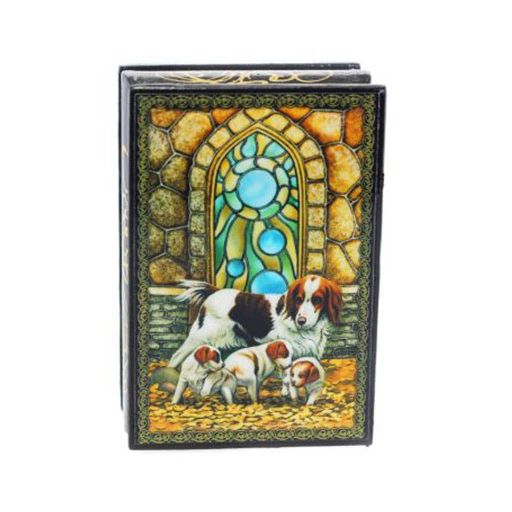 Dog and puppies on a decorative book, with a stained glass window background.