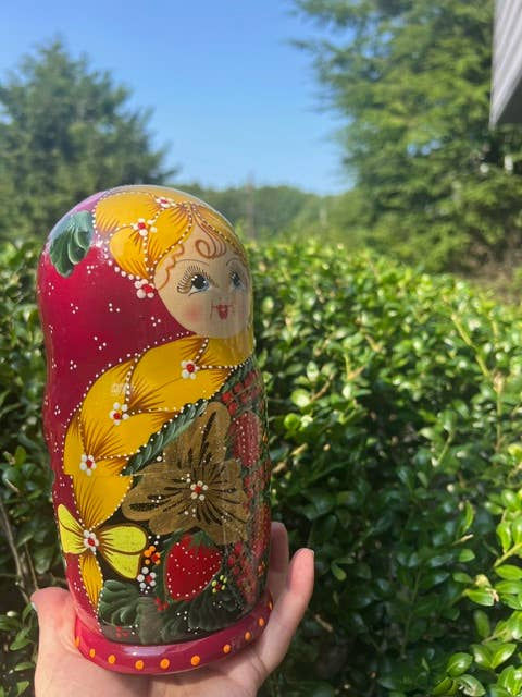 Thumbnail: Hand holding LIGHT GREEN Floral Nesting Dolls Set, 5 Pcs/6", vibrant colors, nature background.