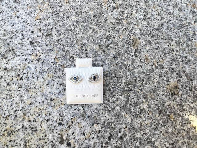 Thumbnail: Pair of eye-shaped earrings on a white card labeled 