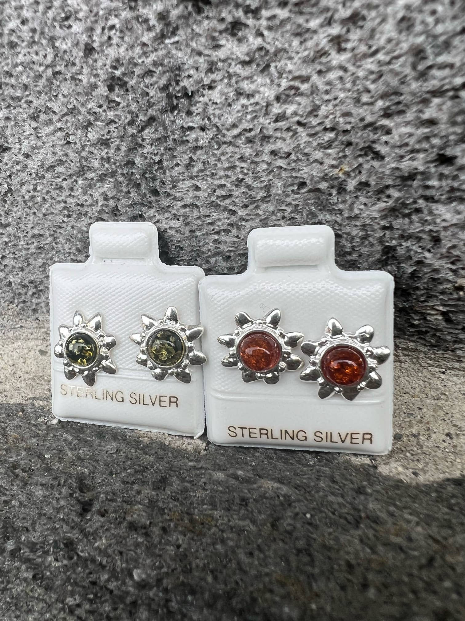 Two pairs of silver earrings, each with the words STERLING SILVER visible.