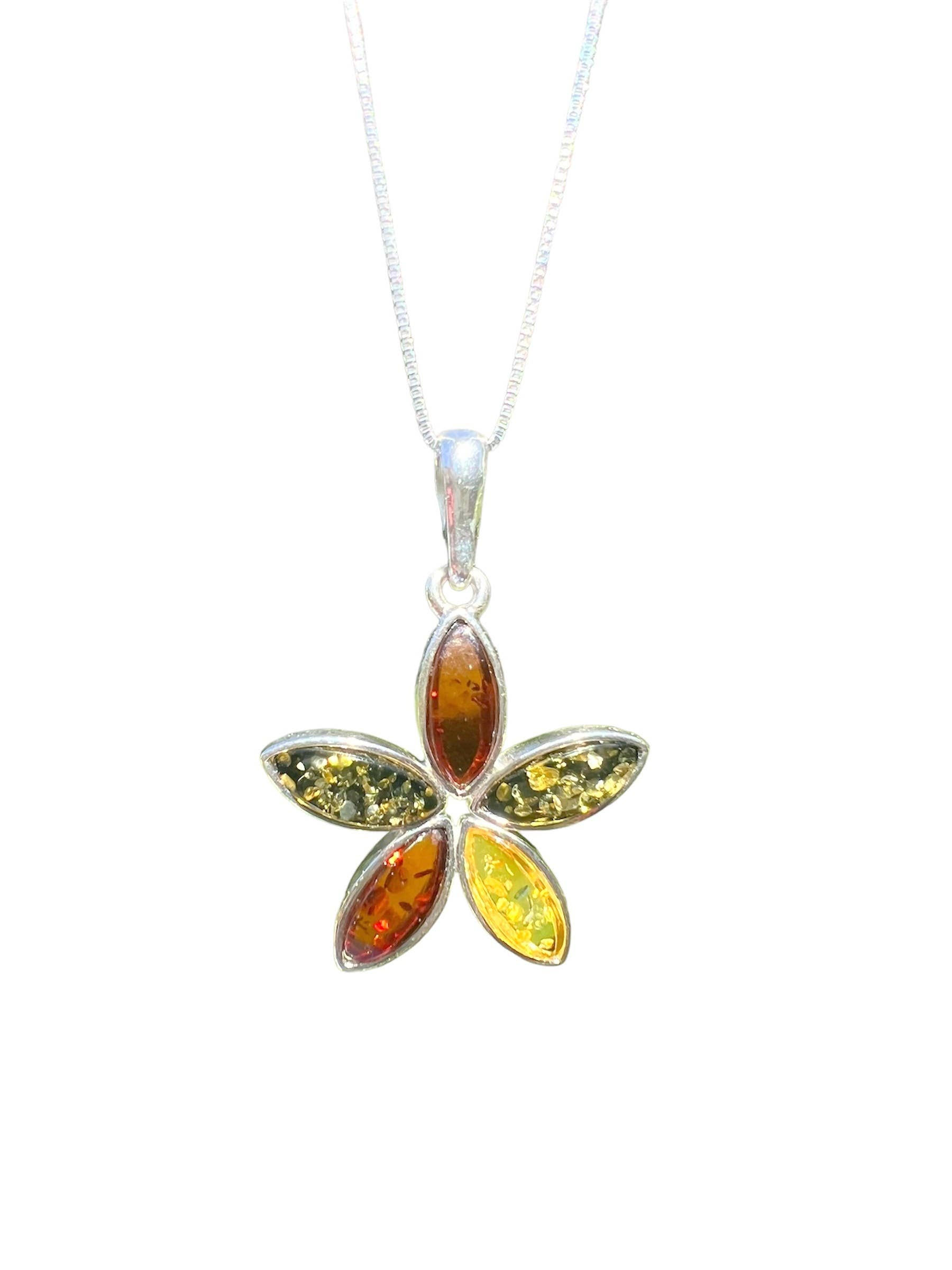 Flower shaped amber pendant necklace on white background with silver chain