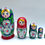 Thumbnail: Set of colorful Matryoshka dolls with flower and face details on a white background