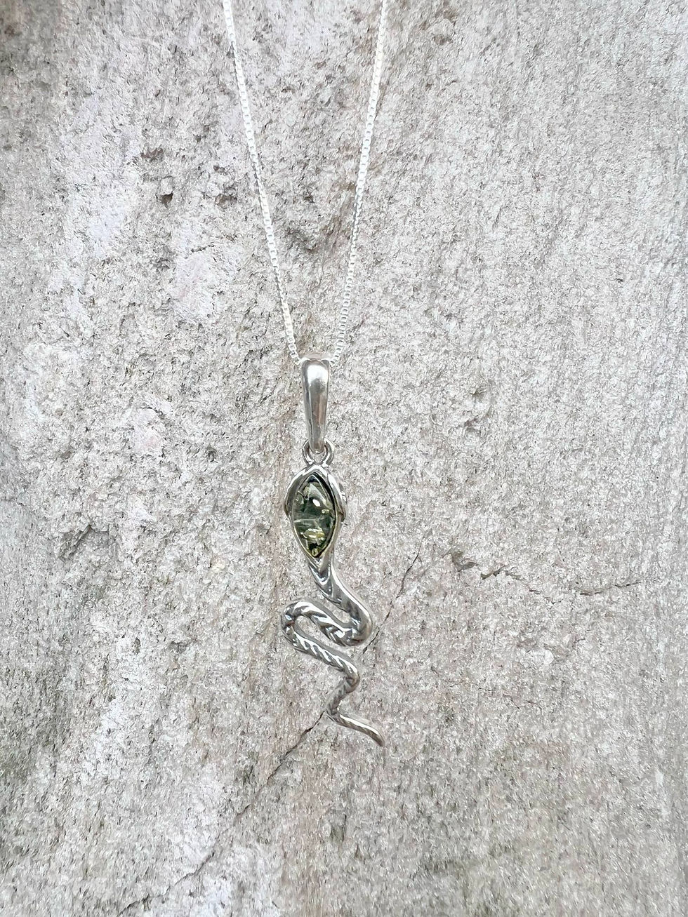 Thumbnail: Silver snake pendant necklace with a green gemstone, against a textured background.