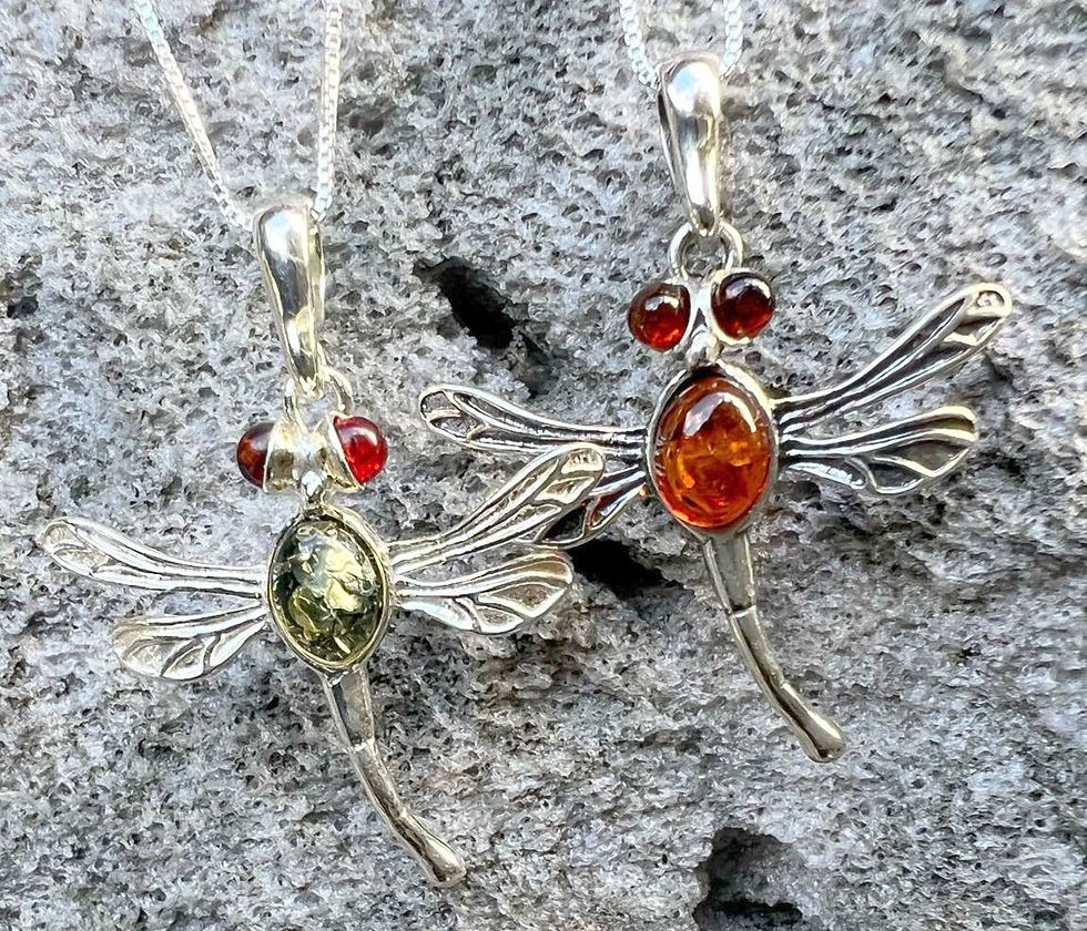 Thumbnail: Two dragonfly pendant necklaces with amber and green stone against gray stone background