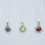 Thumbnail: Three silver necklaces with sunburst pendants on white background jewelry.
