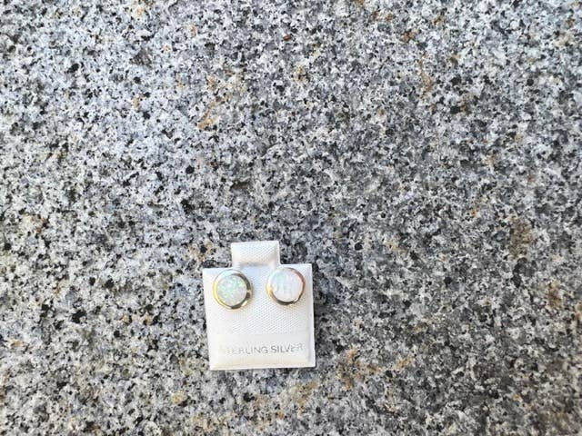 Thumbnail: White and gold earrings on display, brand name visible on display card