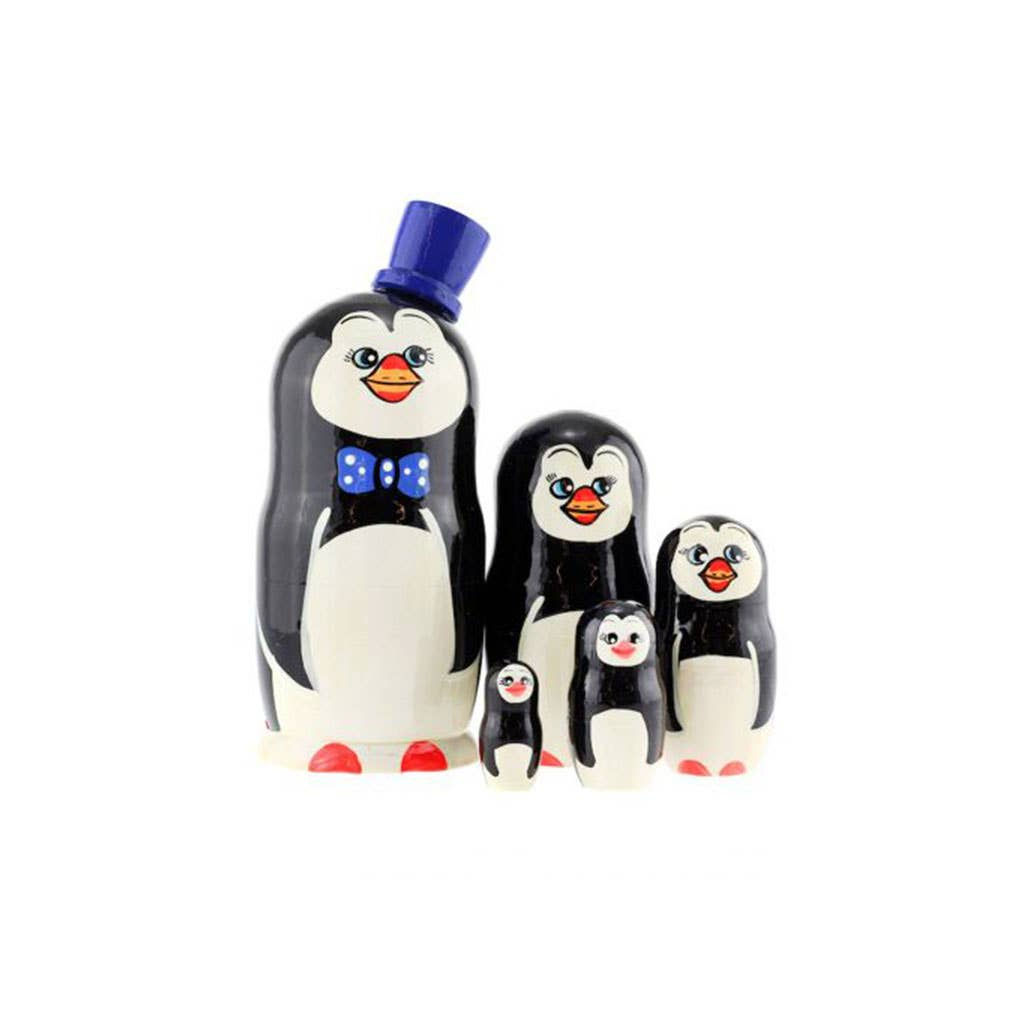 Penguin stacking dolls, with a blue hat and bow tie on display.