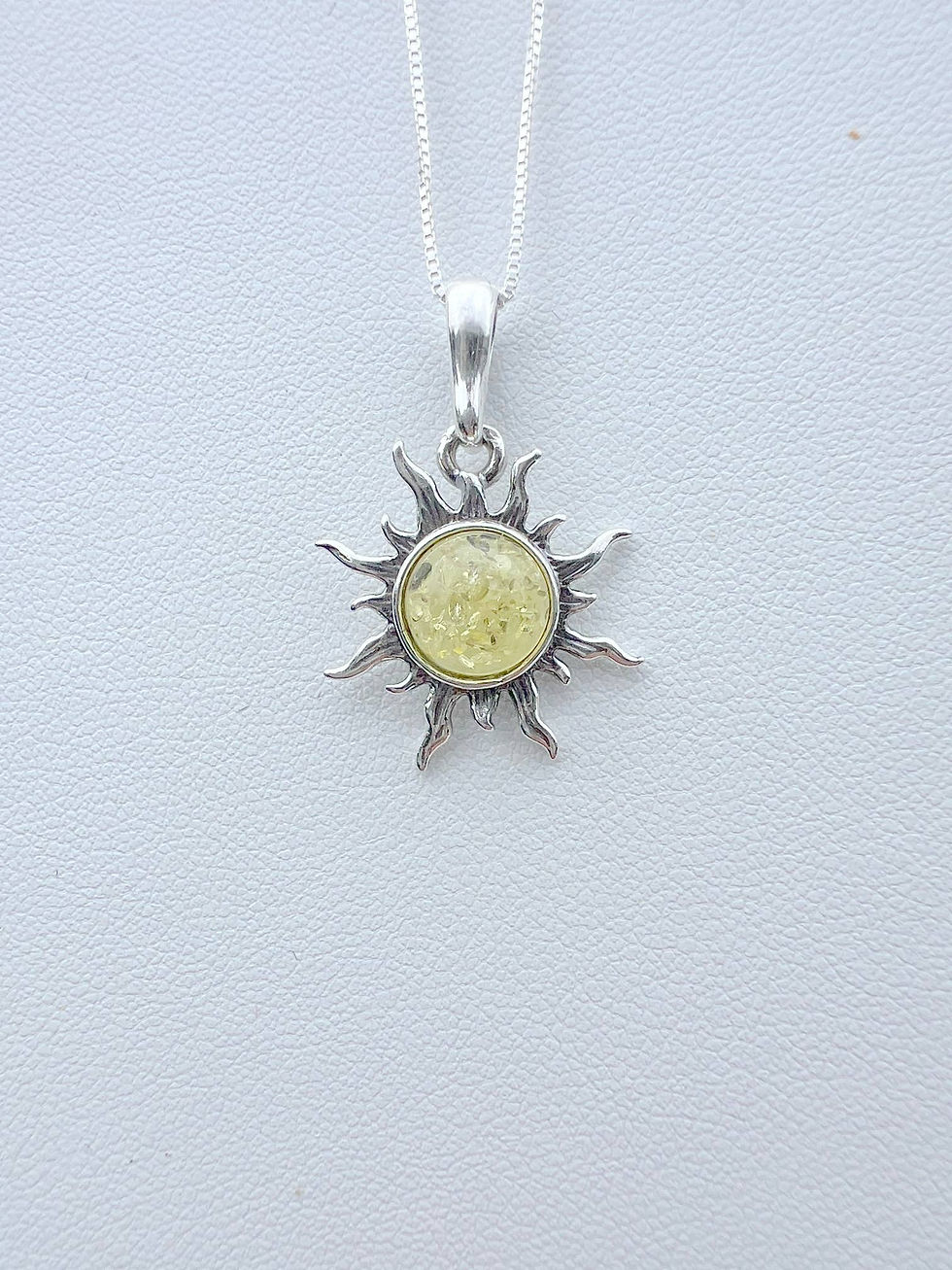 Thumbnail: Silver sun pendant necklace with yellow stone, jewelry, white background.