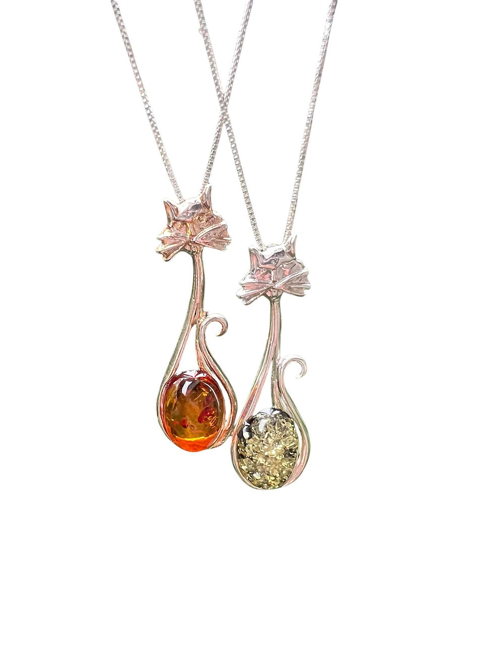 Two necklaces with amber pendants hanging against a white background.