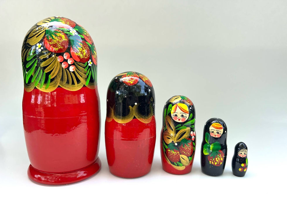 Set of Russian nesting dolls, intricate floral designs, red and black.