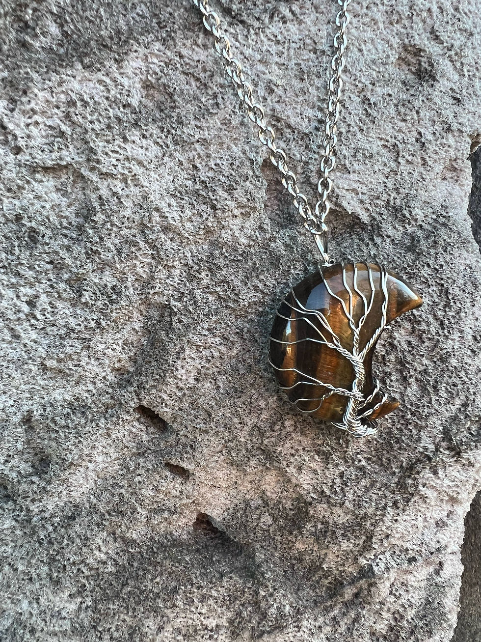 Thumbnail: Silver necklace with tree pendant on a stone background; jewelry closeup
