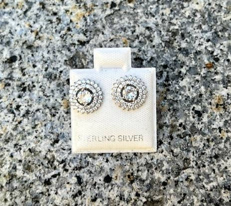 Sterling silver earrings on white display card with a granite background