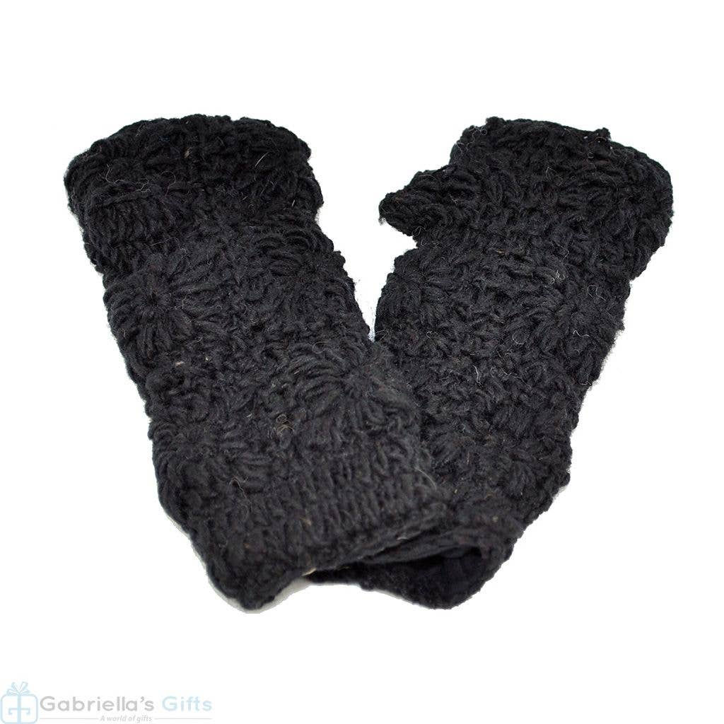 Pair of black textured mittens on a white surface, Gabriela's Gifts visible.