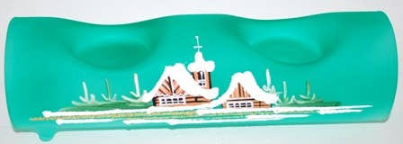 Green glass candle holder with painted houses and snow scene detail.