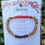 Thumbnail: Healing bracelet with Coral beads and text on a white card.