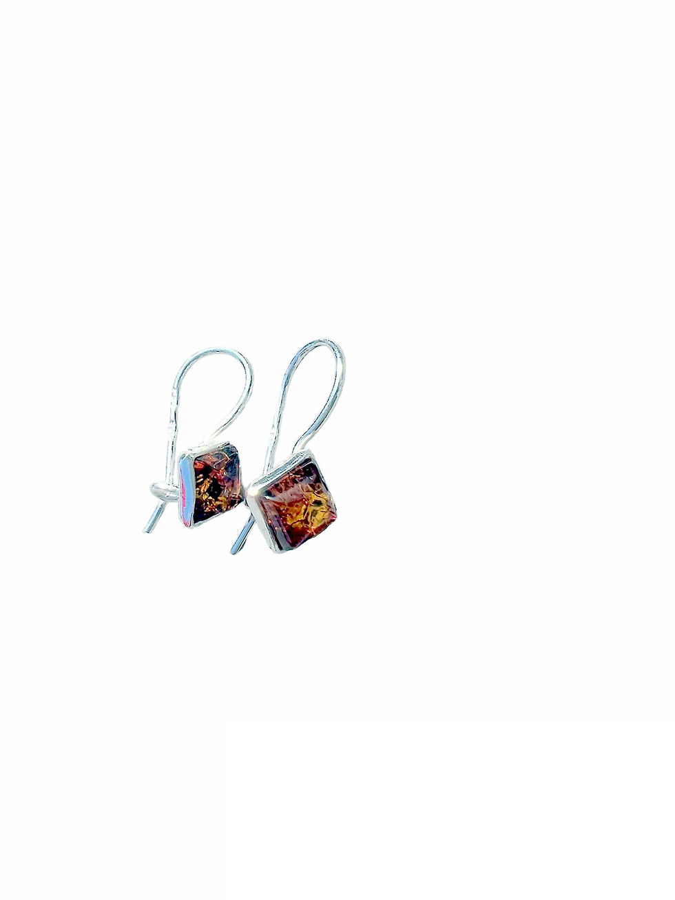 Silver earrings with square amber stones on white background, jewelry.