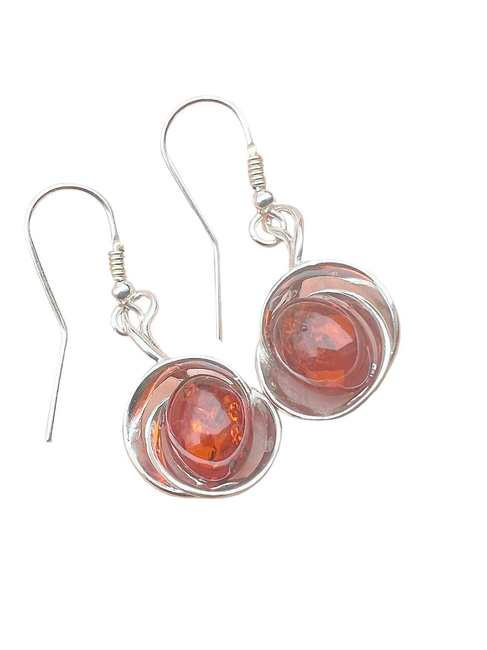 Silver earrings with amber stones, elegant design, isolated on white background